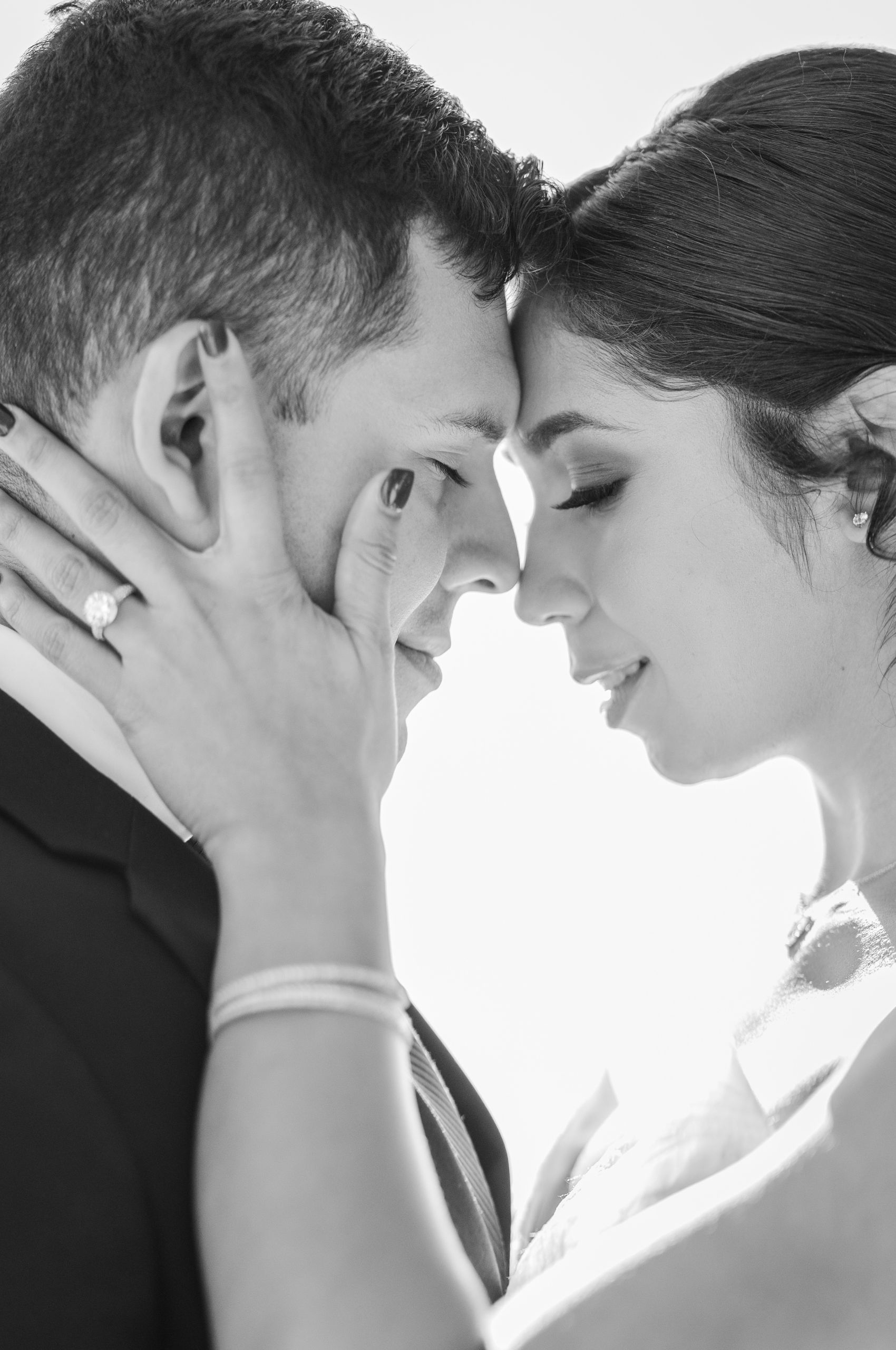 Houston bride and groom embracing on their wedding day in a black and white photograph by Beth Sheridan.