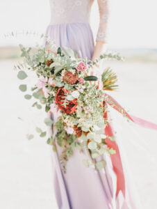 A bride showcasing predicted wedding fashion trends for 2025 in elegant attire.