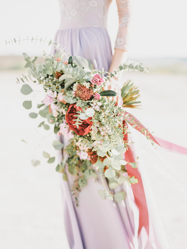 A bride showcasing predicted wedding fashion trends for 2025 in elegant attire.