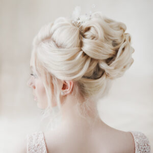 A bride showcasing a modern bridal hairstyle trend for 2025 with elegant accessories.