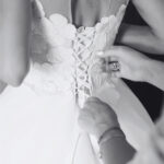 Bride getting dressed in a stunning black and white wedding photography style.