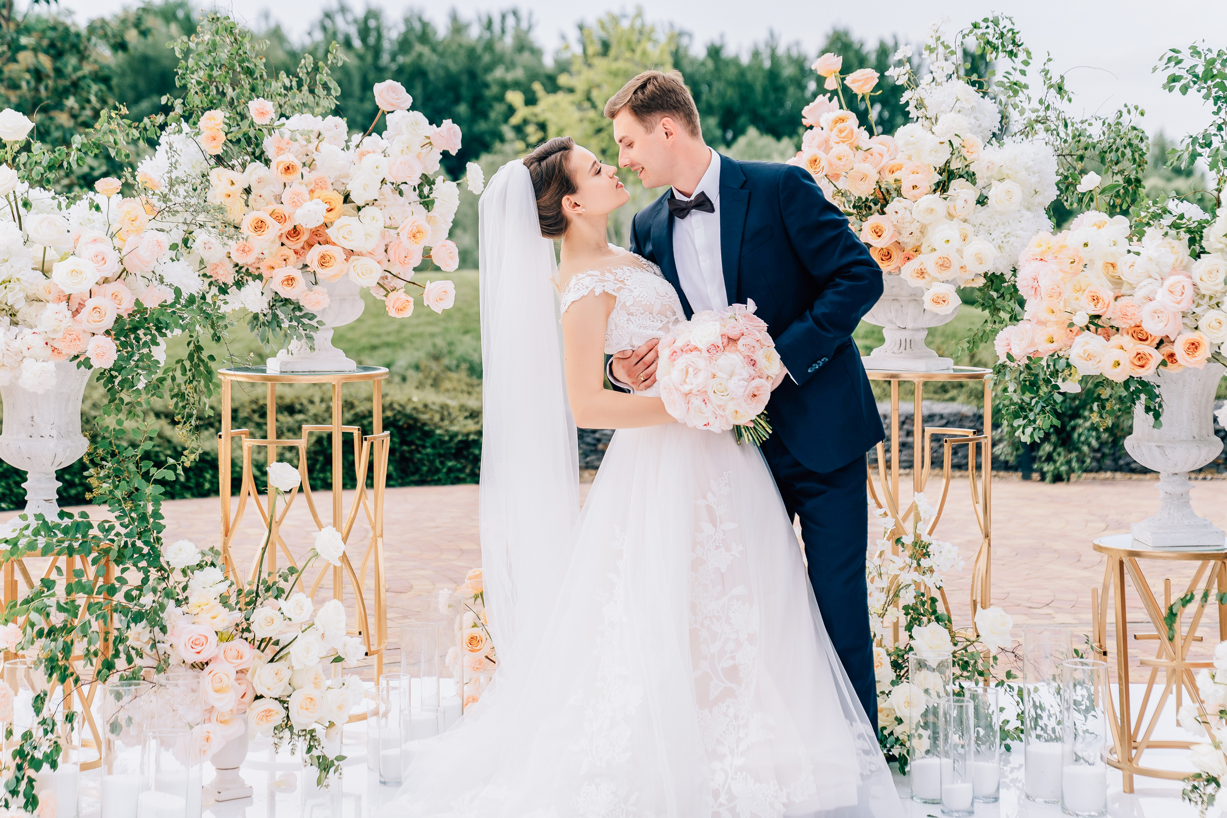 A luxurious wedding scene where the bride and groom share an intimate moment, feeling fully present in each other's company so they don't miss a moment.