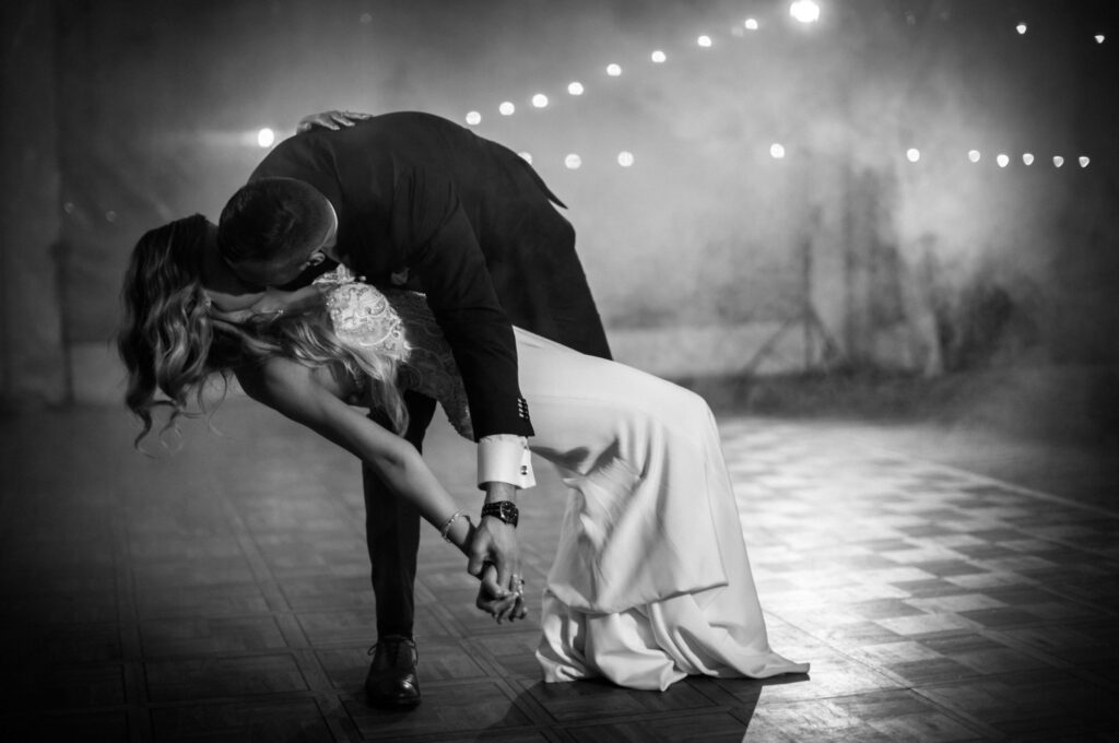 A wedding photographer capturing candid moments during a couple’s first dance.