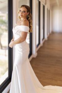 A bride looks out the window having had a stress-free wedding day.