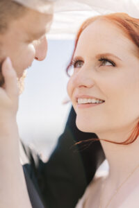 A couple in Houston posing for their engagement photo session at an elegant outdoor location.