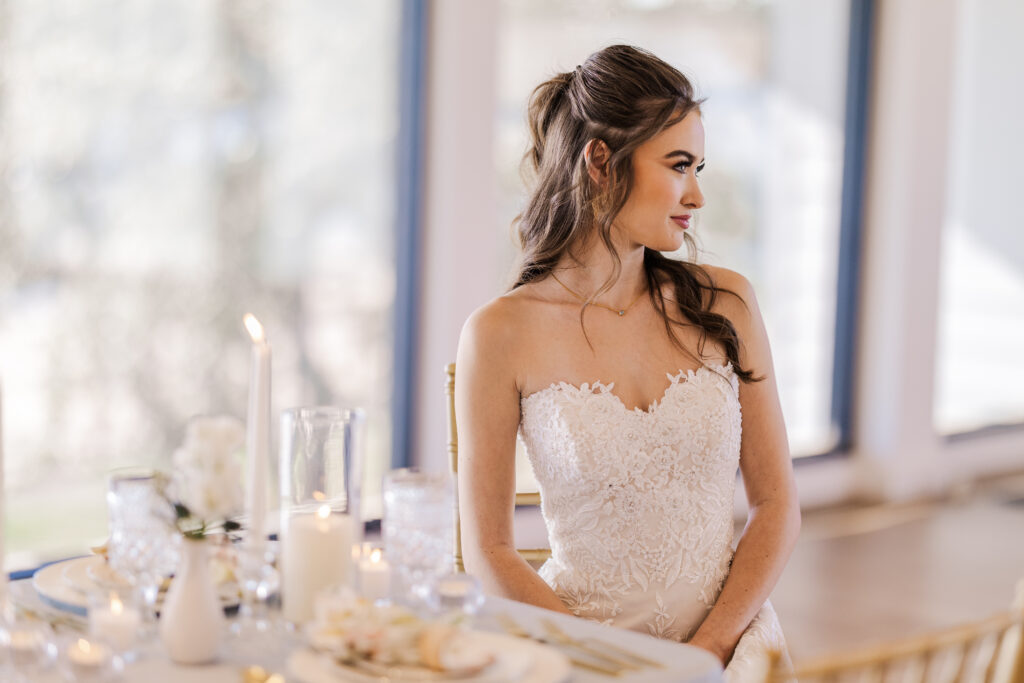 A bride sits at the wedding table enjoying a moment after her smooth ceremony set the tone for the day.