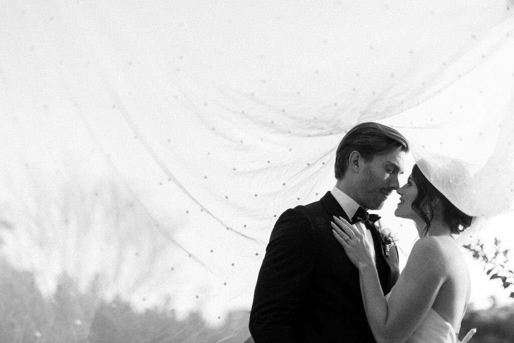 A bride and groom at their wedding in Houston, TX depicted in black and white.